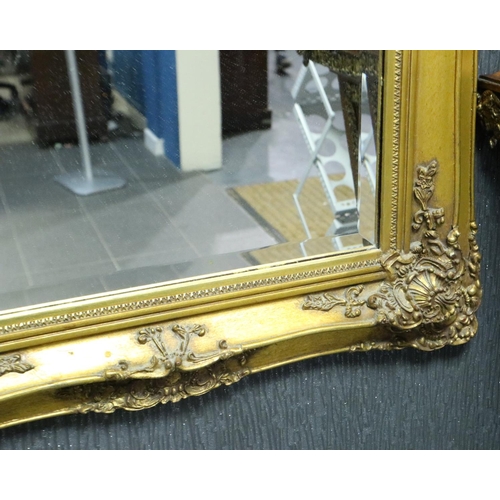 2071 - A 20th century gilt framed hall mirror with resin cherub panel, overall 60 x 115 cm. Not available f... 