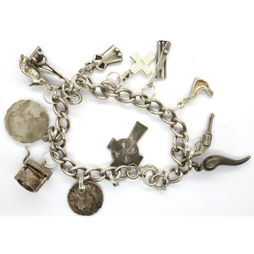 21 - Silver charm bracelet with twelve charms, L: 18 cm, 33g. P&P Group 1 (£14+VAT for the first lot and ... 