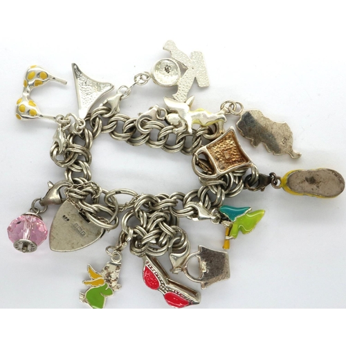 30 - Silver charm bracelet with eleven charms, L: 18 cm, 36g. P&P Group 1 (£14+VAT for the first lot and ... 