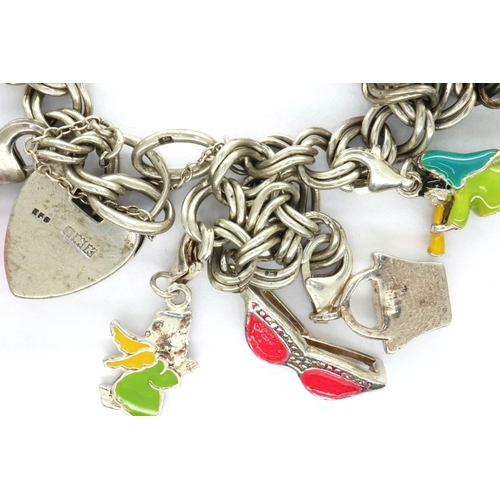 30 - Silver charm bracelet with eleven charms, L: 18 cm, 36g. P&P Group 1 (£14+VAT for the first lot and ... 