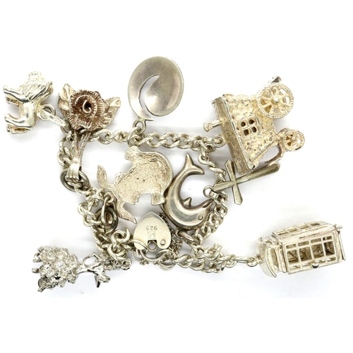 5 - Silver charm bracelet with nine charms, L: 18 cm, 23g. P&P Group 1 (£14+VAT for the first lot and £1... 