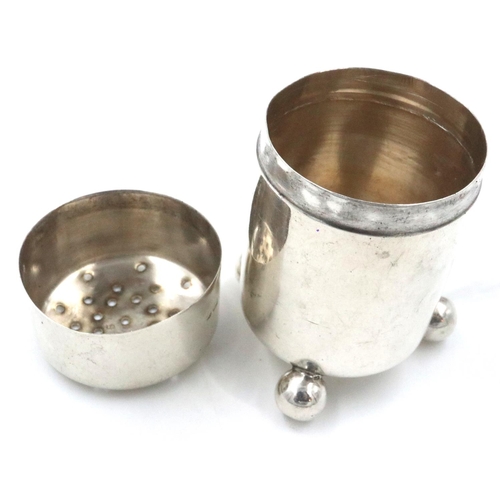 78 - Hallmarked silver pepperette on three supports, Birmingham assay 1910, H: 60 mm, 15g. Dented to body... 