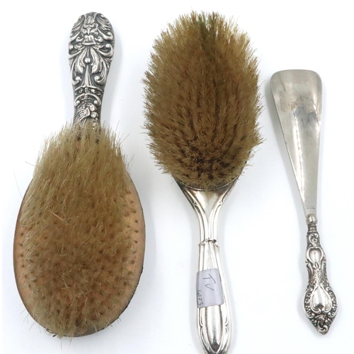 80 - Two hallmarked silver backed brushes and a hallmarked silver handled shoe horn. P&P Group 2 (£18+VAT... 