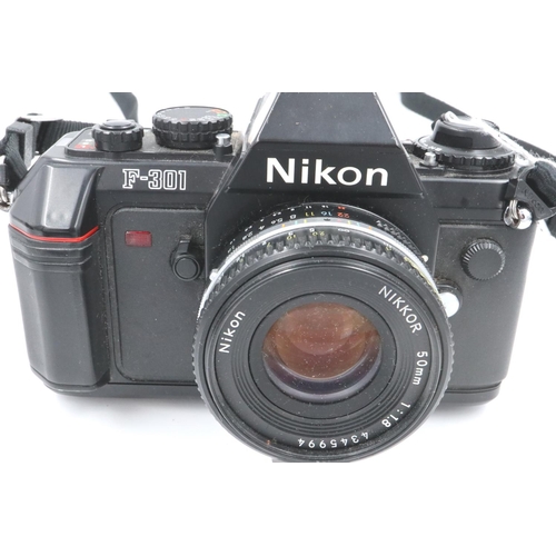 179 - Nikon film camera F301 with Nikkor 50mm F1.8 lens and Nikon leather case, Nikon SP23 flash, bagged. ... 