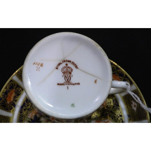 274 - Three small Royal Crown Derby coffee cups and saucers in the 1128 pattern. One cup with star crack t... 