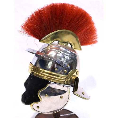 363 - Model Roman Legionnaires helmet on stand, H: 20 cm. P&P Group 3 (£25+VAT for the first lot and £5+VA... 