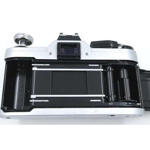 160 - Canon AE-1 35mm SLR camera body with instruction book. P&P Group 1 (£14+VAT for the first lot and £1... 