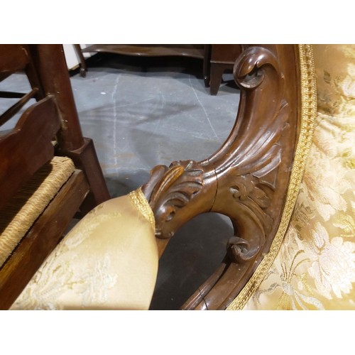 2190 - A Victorian walnut framed parlour chair, with heavily carved frame and upholstered seat, back and ar... 