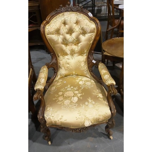 2190 - A Victorian walnut framed parlour chair, with heavily carved frame and upholstered seat, back and ar... 