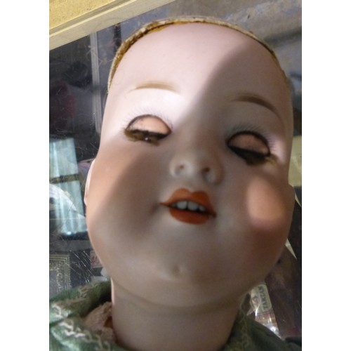 1064 - Quantity of porcelain and wooden dolls. Not available for in-house P&P