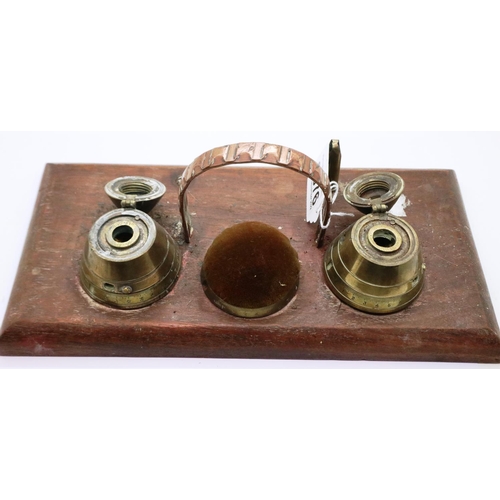 2076 - A trench art desk stand comprising two shell fuses converted to inkwells and blotter, with faults.  ... 