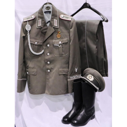 2113 - East German Armoured Division NCO uniform, comprising tunic, trousers, boots, and visor cap with lan... 