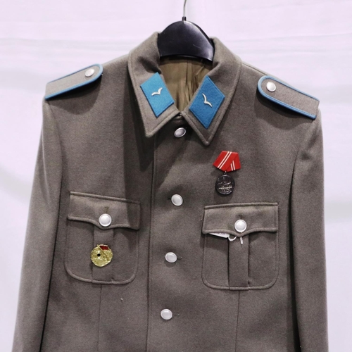 2114 - An East German NVA Luftwaffe NCOs tunic, with awards and visor cap. P&P Group 3 (£25+VAT for the fir... 