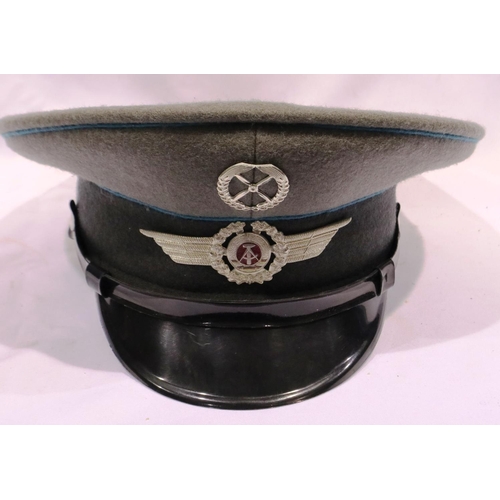 2114 - An East German NVA Luftwaffe NCOs tunic, with awards and visor cap. P&P Group 3 (£25+VAT for the fir... 