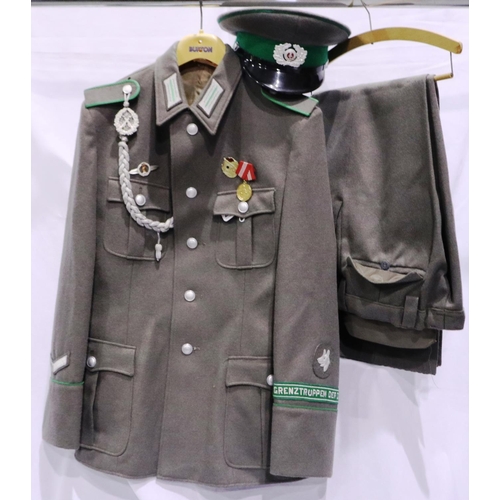 2117 - An East German NVA Border Troops enlisted mans tunic, trousers and visor cap. P&P Group 3 (£25+VAT f... 