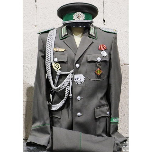 2119 - An East German NVA Border Guards Majors uniform, comprising tunic with awards, aiguillette, trousers... 