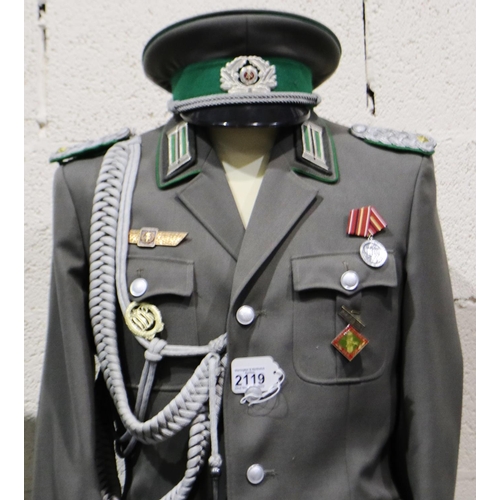 2119 - An East German NVA Border Guards Majors uniform, comprising tunic with awards, aiguillette, trousers... 