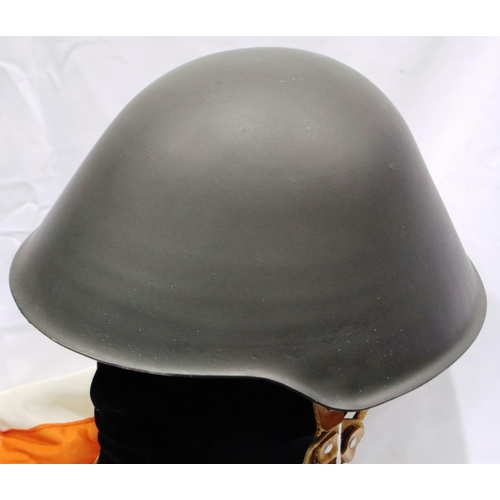 2125 - An East German NVA steel helmet with leather liner and cover. P&P Group 2 (£18+VAT for the first lot... 