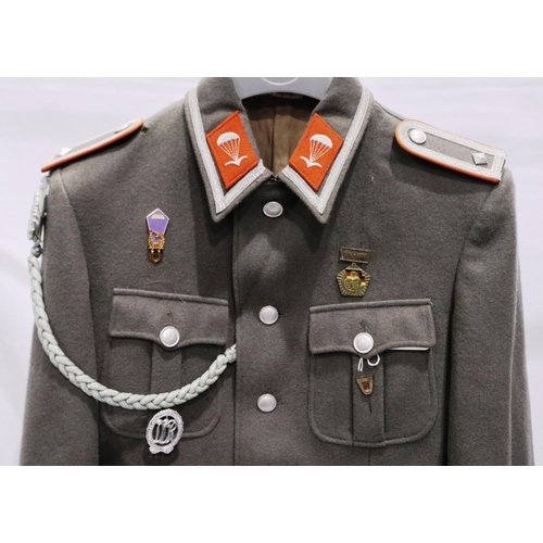 2164 - An East German NVA Paras parade tunic, with lanyard and awards. P&P Group 3 (£25+VAT for the first l... 