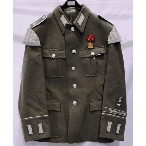 2168 - An East German NVA Bandsman parade tunic, with cuff title and awards. P&P Group 3 (£25+VAT for the f... 