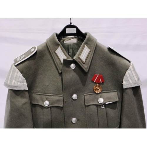 2168 - An East German NVA Bandsman parade tunic, with cuff title and awards. P&P Group 3 (£25+VAT for the f... 