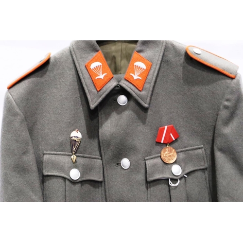 2170 - An East German NVA Paras parade tunic, with awards. P&P Group 3 (£25+VAT for the first lot and £5+VA... 