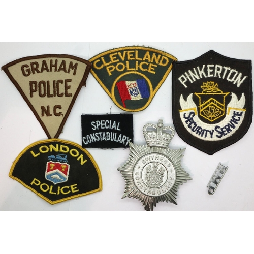 2192 - Mixed world Police Forces patches, Gwynedd Constabulary helmet plate etc. P&P Group 1 (£14+VAT for t... 