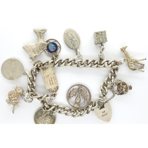 11 - Silver charm bracelet with eleven charms, some hallmarked, L: 16 cm, combined 42g. P&P Group 1 (£14+... 