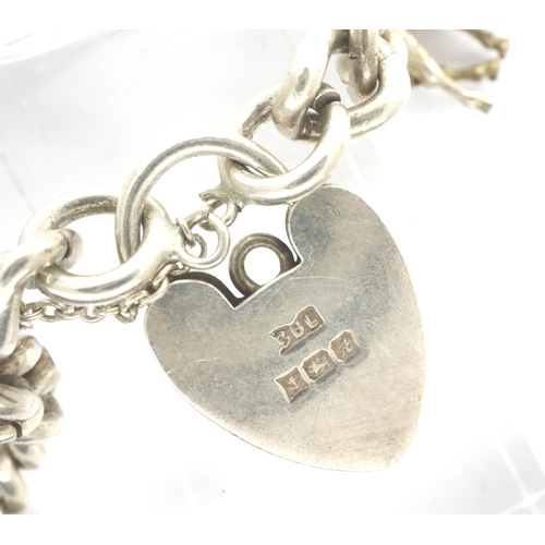 11 - Silver charm bracelet with eleven charms, some hallmarked, L: 16 cm, combined 42g. P&P Group 1 (£14+... 