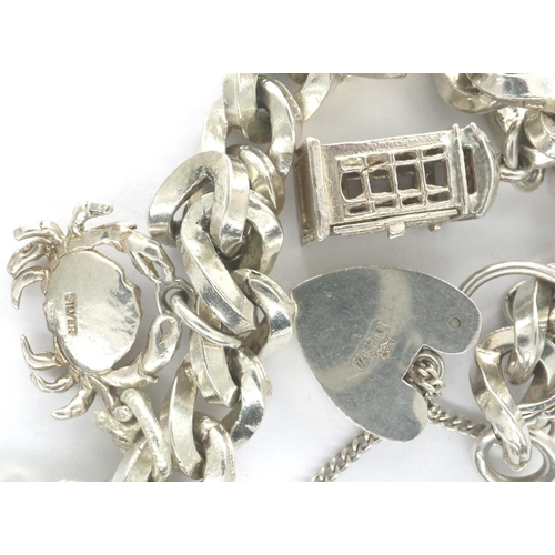 43 - Silver chain bracelet with hallmarked silver padlock clasp and three charms, L: 14 cm, combined 46g.... 