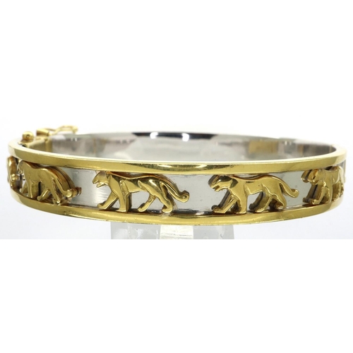 66 - An 18ct white and yellow gold bangle, in the Cartier style, with panthers set into a channel, 60 x 5... 