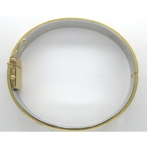 66 - An 18ct white and yellow gold bangle, in the Cartier style, with panthers set into a channel, 60 x 5... 