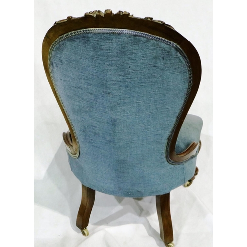 3010 - A Victorian low seated parlour chair with heavily carved walnut frame and later buttoned upholstery.... 