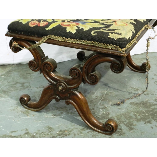 3024 - A Victorian walnut framed stool with Savoronola form supports and wool work upholstered top, 65 x 48... 