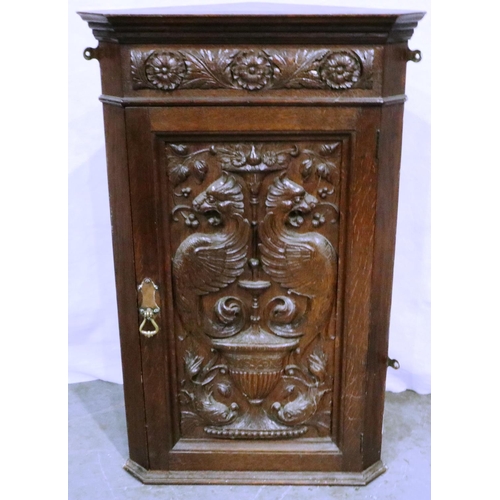 3034 - Heavily carved oak single door wall hanging cupboard, with Griffins and flora, 46 x 71 cm H. Not ava... 