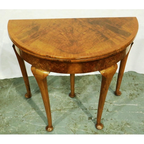 3056 - An early 20th century walnut demi-lune games table with fold over top and cabriole supports, D: 84 c... 