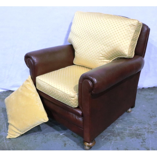 3062 - A 20th century burgundy leather fireside chair, the seat and back cushions upholstered in gold. Not ... 