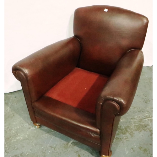 3062 - A 20th century burgundy leather fireside chair, the seat and back cushions upholstered in gold. Not ... 