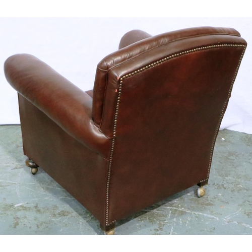 3062 - A 20th century burgundy leather fireside chair, the seat and back cushions upholstered in gold. Not ... 