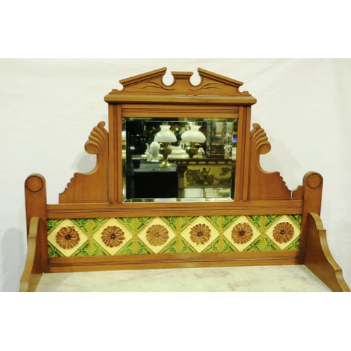 3065 - A Victorian pine washstand with marble top, tiled and mirrored upstand and a base of drawers and cup... 