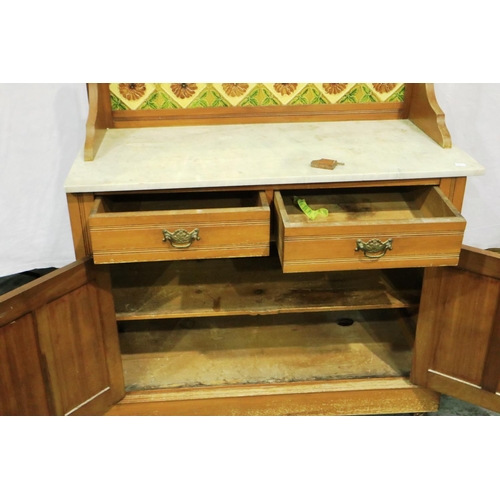 3065 - A Victorian pine washstand with marble top, tiled and mirrored upstand and a base of drawers and cup... 