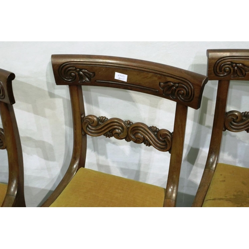 3067 - A set of four regency period walnut framed dining chairs with later upholstered drop in seats and ca... 