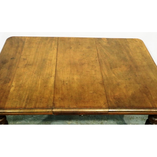 3071 - A Victorian walnut wind out extending dining table having one additional leaf and turned supports, 1... 