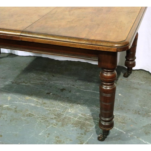 3071 - A Victorian walnut wind out extending dining table having one additional leaf and turned supports, 1... 