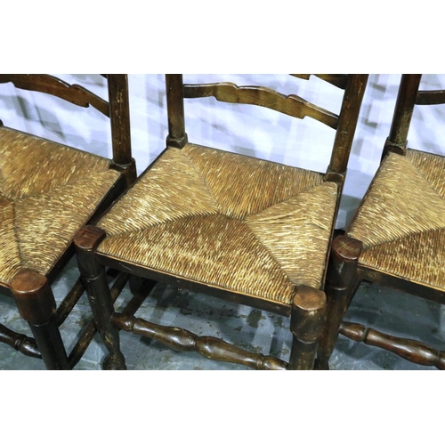 3078 - Four ladder back country oak kitchen chairs with rushed seats and ball feet. Not available for in-ho... 