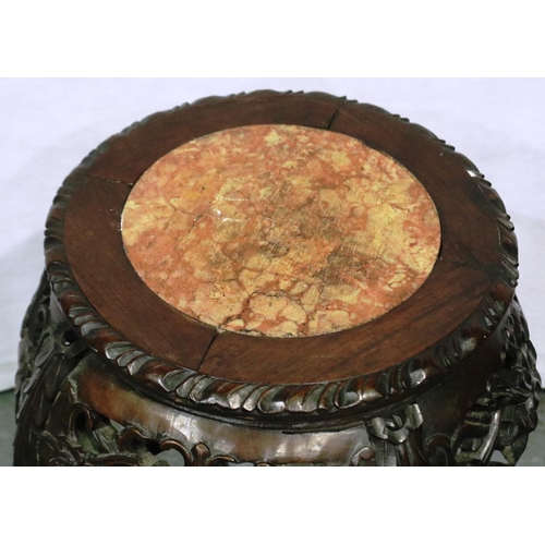 3080 - An early 20th century Oriental vase stand with a heavily carved base and rouge marble inset top, H: ... 