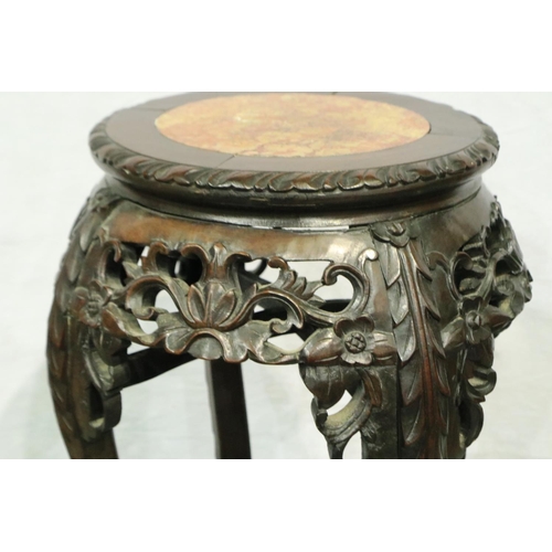 3080 - An early 20th century Oriental vase stand with a heavily carved base and rouge marble inset top, H: ... 