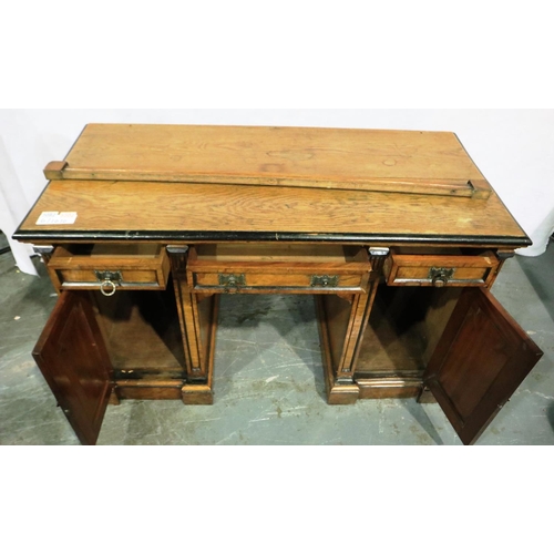 3082 - An oak and pollard oak Arts and Crafts writing desk, double pedestal with cupboards and drawers, in ... 