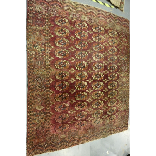 3214 - A large Persian knotted floor rug, red ground with complex geometric designs, 255 x 215 cm. Not avai... 