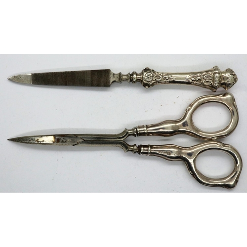 104 - Hallmarked silver handled nail scissors and nail file, Birmingham assay, largest L: 12 cm, 26g. P&P ... 